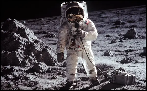 Astronaut standing on a rocky lunar landscape